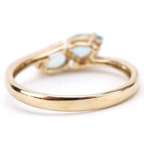 3203 - 9ct gold teardrop aquamarine and diamond crossover ring, size N, 1.7g