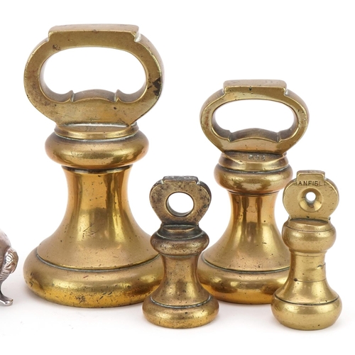 1234 - Four brass bell weights together with a pewter hip flask and a pair of plated salt and pepper shaker... 