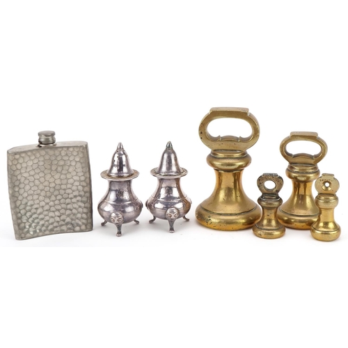 1234 - Four brass bell weights together with a pewter hip flask and a pair of plated salt and pepper shaker... 