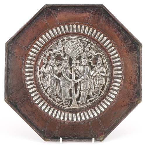 207 - 20th century Indian white metal octagonal plate, the central panel decorated with four figures holdi... 