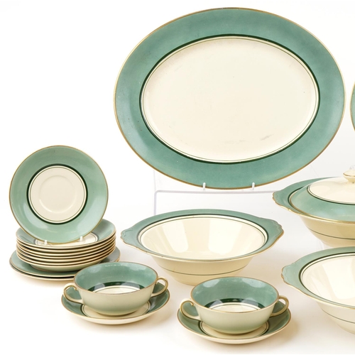 543 - Gray's Pottery part dinner service finished in green and gilt, the platter 41cm wide