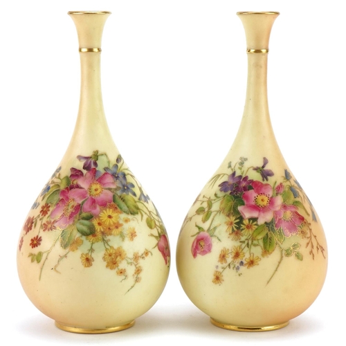 37 - Pair of Royal Worcester floral decorated blush ivory bottle vases, model numbers F105, each 21cm hig... 