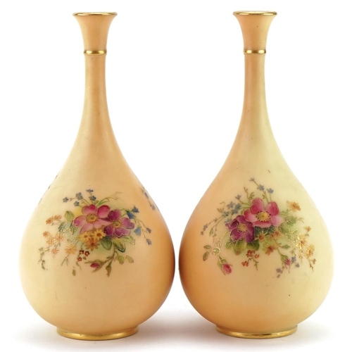 37 - Pair of Royal Worcester floral decorated blush ivory bottle vases, model numbers F105, each 21cm hig... 