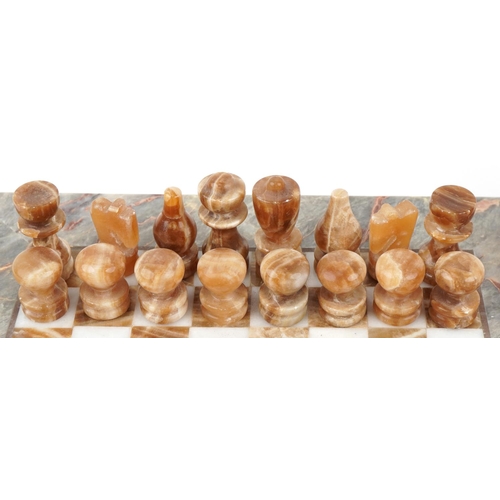 2025 - Mid to late 20th century marble chequer board together with two marble chess sets, the board 36cm x ... 