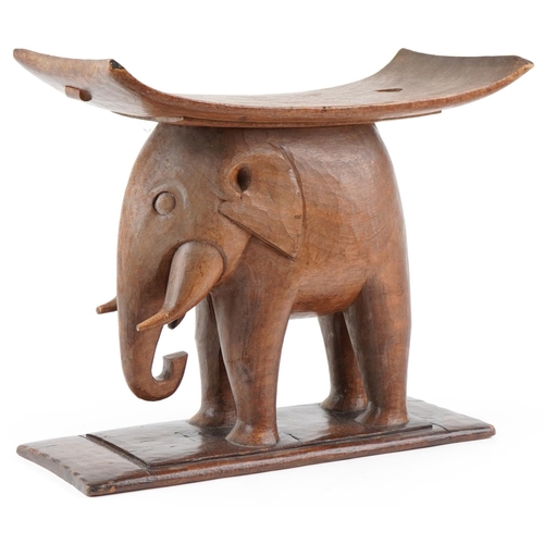 1044 - 20th century African Ashanti hardwood stool in the form of an elephant, 52cm H x 60cm W x 29cm D