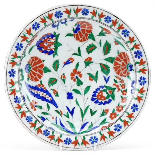 133 - Ottoman Turkish Iznik glazed pottery charger, 20th century, hand painted with stylized flowers, 31cm... 