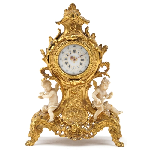 189 - Miniature Rococo style gilt spelter mantle clock mounted with ivory coloured Putti, 12cm high