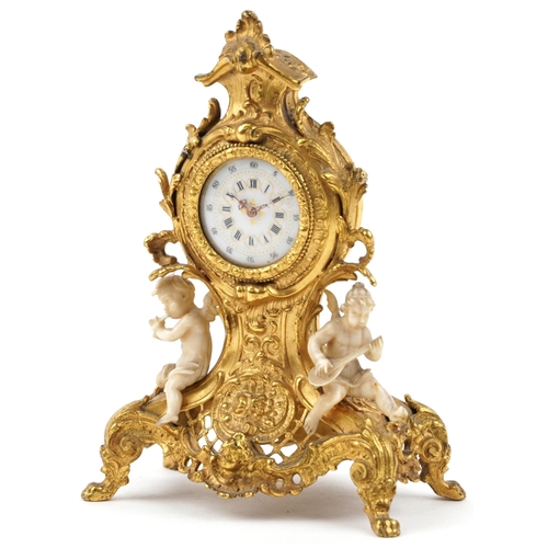 189 - Miniature Rococo style gilt spelter mantle clock mounted with ivory coloured Putti, 12cm high