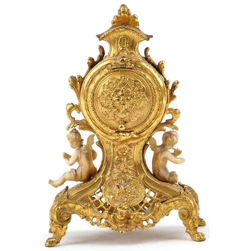 189 - Miniature Rococo style gilt spelter mantle clock mounted with ivory coloured Putti, 12cm high