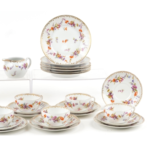 1147 - German porcelain part tea service hand painted and gilded with flowers, the largest 19.5cm in diamet... 