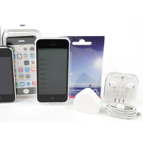 1129 - Three Apple iPhones, two with boxes, comprising 8GB iPhone 3GS model A1303, 8GB iPhone 5C model A150... 