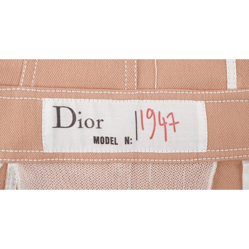 1441 - Christian Dior Boutique Paris ladies peach denim jacket with white piping, with engraved buttons and... 