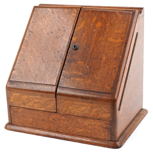 194 - Late Victorian oak stationery box, the sloped hinged top revealing a compartmentalised interior, 33c... 