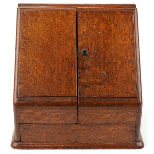 194 - Late Victorian oak stationery box, the sloped hinged top revealing a compartmentalised interior, 33c... 