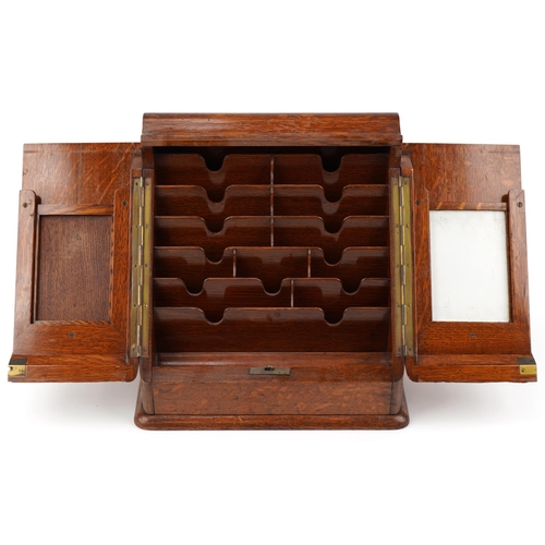 194 - Late Victorian oak stationery box, the sloped hinged top revealing a compartmentalised interior, 33c... 