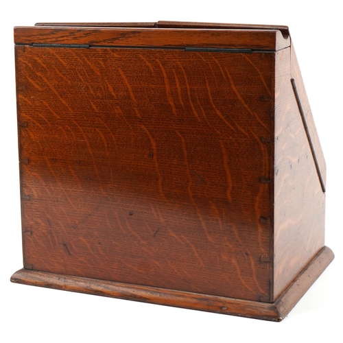 194 - Late Victorian oak stationery box, the sloped hinged top revealing a compartmentalised interior, 33c... 