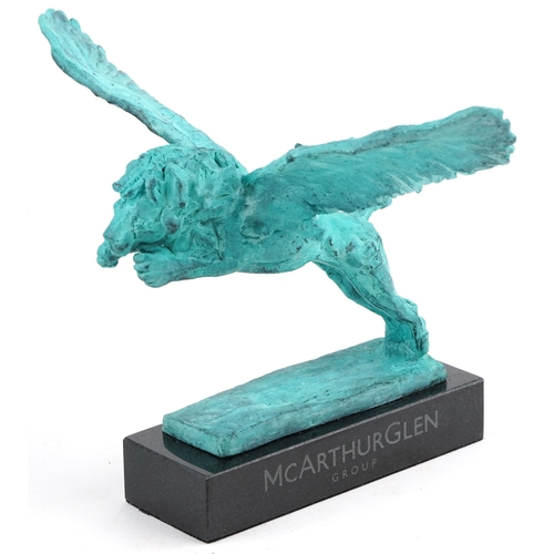 526 - Mark Coreth for McArthur Glen Group, verdigris bronze figure of a winged lion raised on a black slat... 