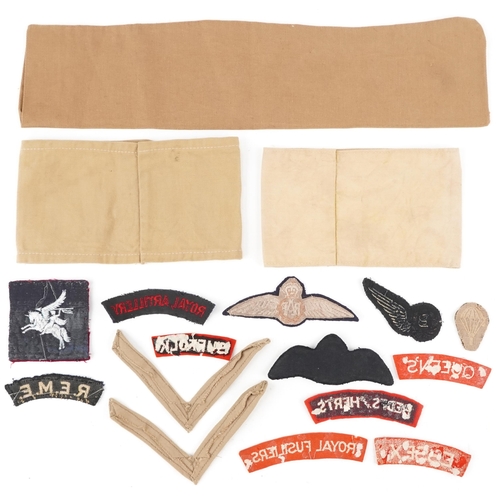 2662 - British military World War II insignia and militaria including shoulder titles, armbands, pilot wing... 