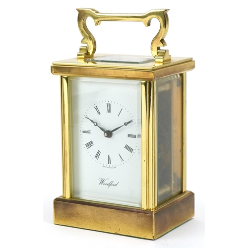 230 - Woodford, brass cased carriage clock with bevelled glass and swing handle, 12cm high