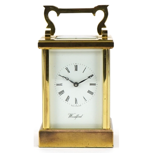 230 - Woodford, brass cased carriage clock with bevelled glass and swing handle, 12cm high