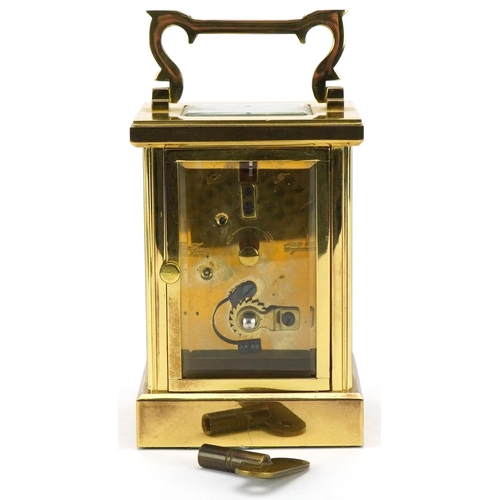 230 - Woodford, brass cased carriage clock with bevelled glass and swing handle, 12cm high