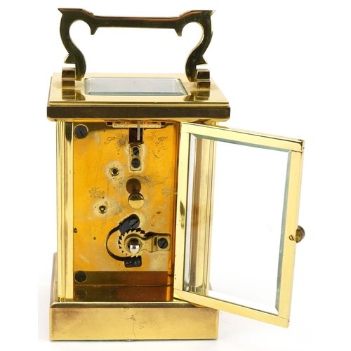 230 - Woodford, brass cased carriage clock with bevelled glass and swing handle, 12cm high