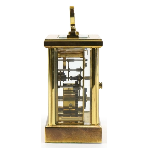 230 - Woodford, brass cased carriage clock with bevelled glass and swing handle, 12cm high