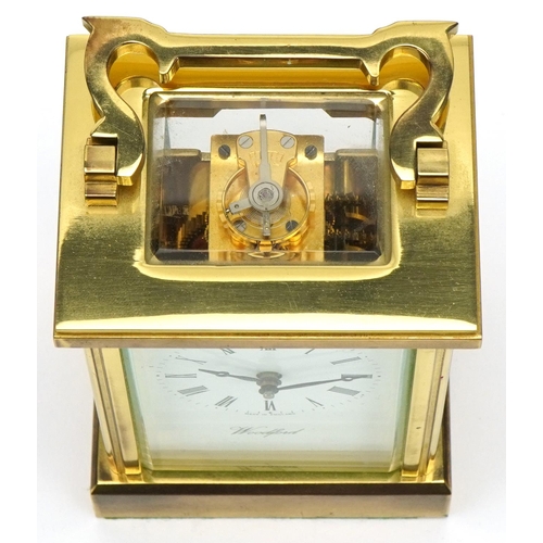 230 - Woodford, brass cased carriage clock with bevelled glass and swing handle, 12cm high