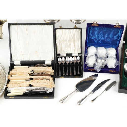 1198 - Mixed group of plated items including a four piece tea set, circular tray, cased fish knives and for... 