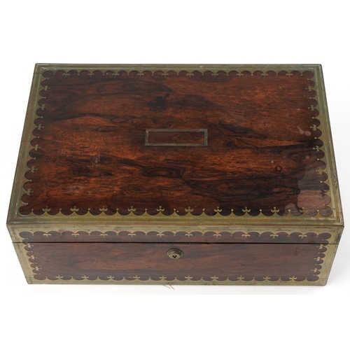 338 - Regency rosewood and brass inlaid writing slope, the hinged top revealing a blue gilt tooled leather... 