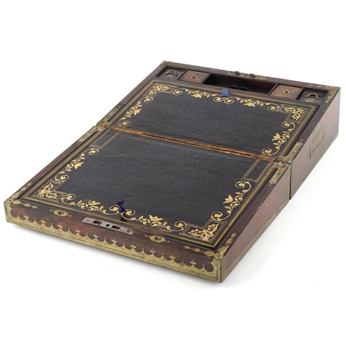 338 - Regency rosewood and brass inlaid writing slope, the hinged top revealing a blue gilt tooled leather... 