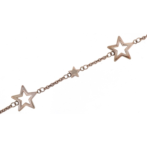 3106 - Tiffany & Co .925 silver bracelet of star link form together with a Tiffany pouch, box and bag.