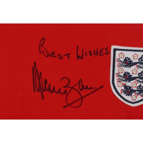 2485 - Signed replica England jumper signed by Alan Ball, framed and glazed, 87cm x 62cm