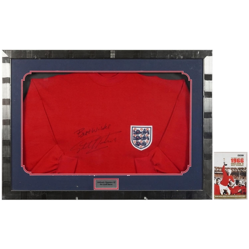 2486 - Signed replica England jumper by Sir Geoff Hurst, framed and glazed, 87cm x 62cm, together with a Wo... 