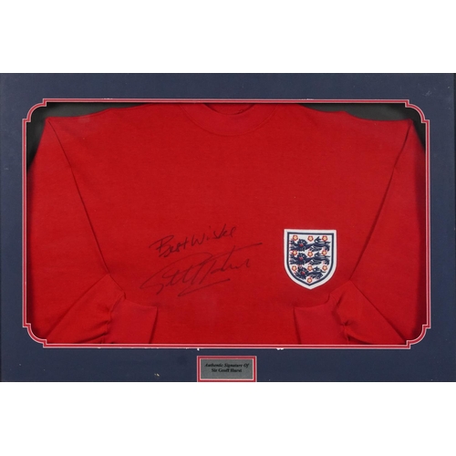 2486 - Signed replica England jumper by Sir Geoff Hurst, framed and glazed, 87cm x 62cm, together with a Wo... 