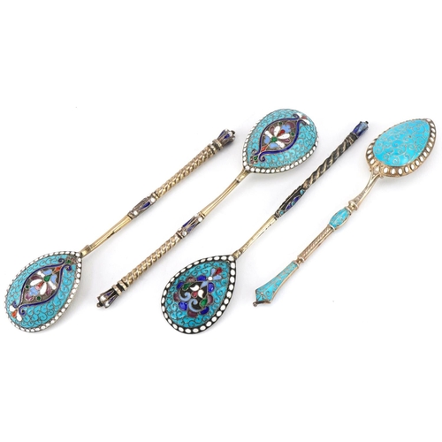 455 - Four silver gilt and champlevé enamel spoons with impressed Russian marks, the largest 11cm in lengt... 