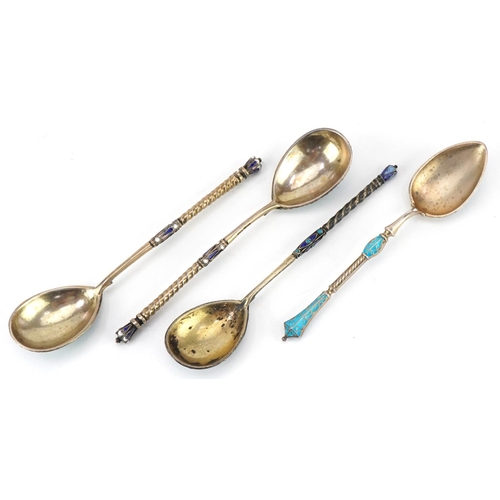 455 - Four silver gilt and champlevé enamel spoons with impressed Russian marks, the largest 11cm in lengt... 