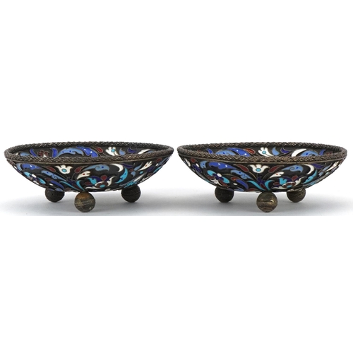 454 - Pair of circular silver and champlevé enamel dishes raised on three ball feet, impressed Russian mar... 