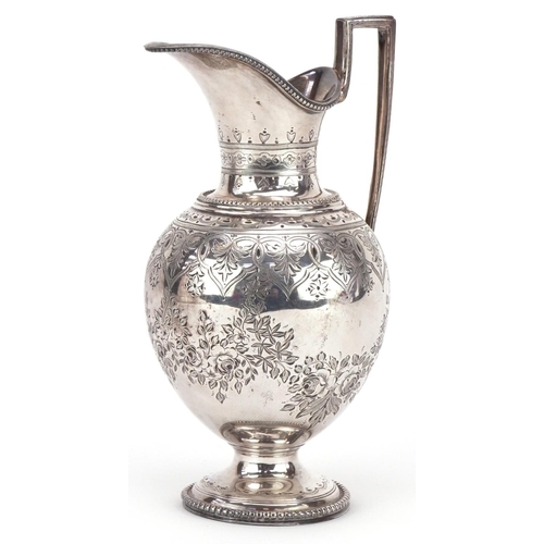 399 - 19th century continental silver milk jug with engraved decoration raised on a circular base, bearing... 