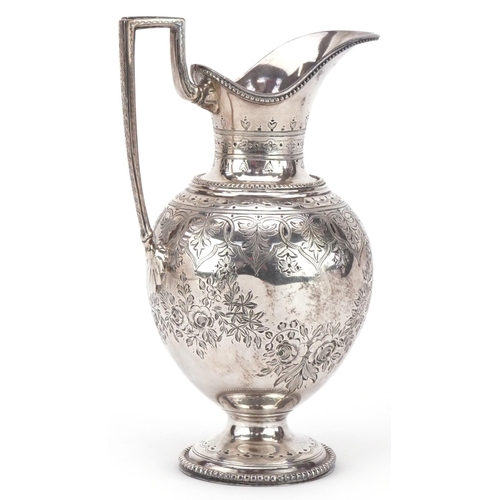 399 - 19th century continental silver milk jug with engraved decoration raised on a circular base, bearing... 