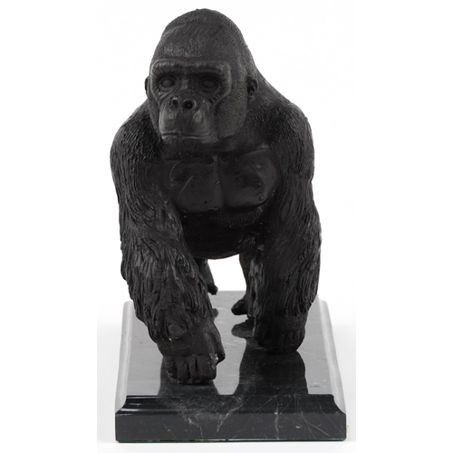 283 - Patinated bronze study of a gorilla raised on a black marble base, 20cm in length