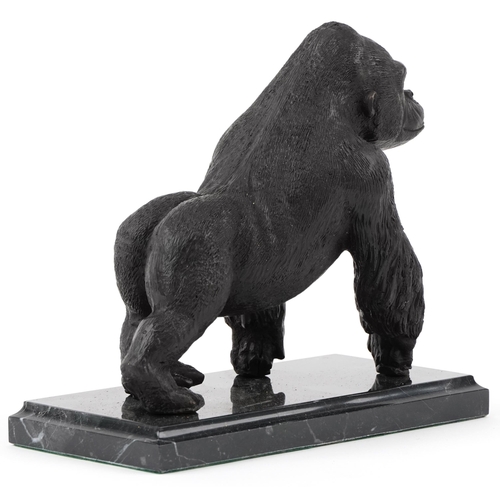 283 - Patinated bronze study of a gorilla raised on a black marble base, 20cm in length