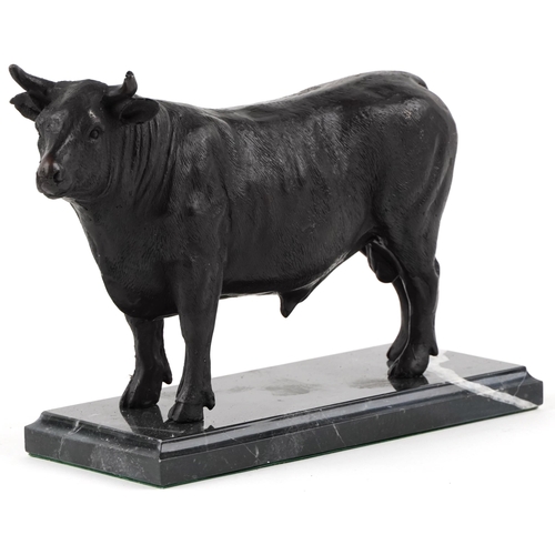 282 - Patinated bronze study of a bull raised on a black marble base, 26cm in length