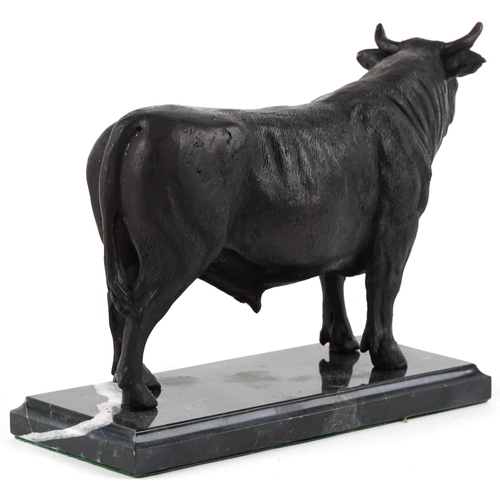 282 - Patinated bronze study of a bull raised on a black marble base, 26cm in length