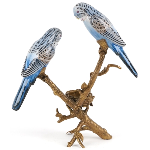 1179 - Continental porcelain and gilt brass candlestick in the form of two budgies on a branch a nest, 26cm... 