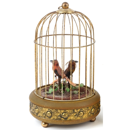 10 - 20th century tinplate musical automaton bird in a cage, probably German, 34cm high, together with a ... 