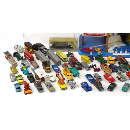 2036 - International plastic toy garage together with a large collection of unboxed diecast models includin... 