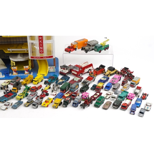 2036 - International plastic toy garage together with a large collection of unboxed diecast models includin... 