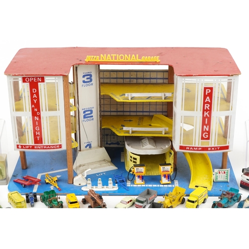 2036 - International plastic toy garage together with a large collection of unboxed diecast models includin... 