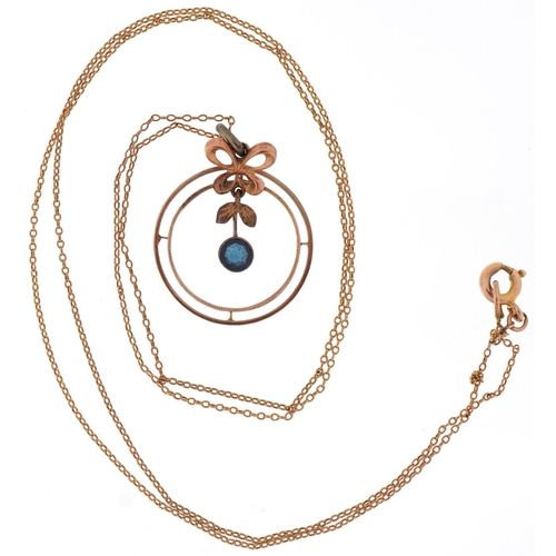 3199 - 9ct gold and sapphire necklace, the central drop sapphire within a butterfly and circular mount, 1.8... 